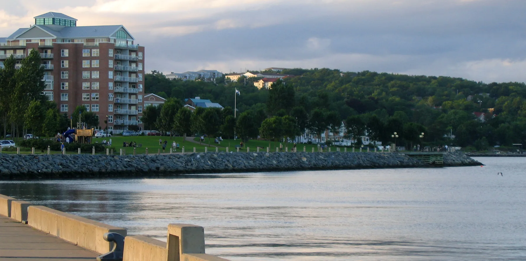 The Bedford waterfront on the Bedford Basin, with a condo building, waterfront park and boardwalk.