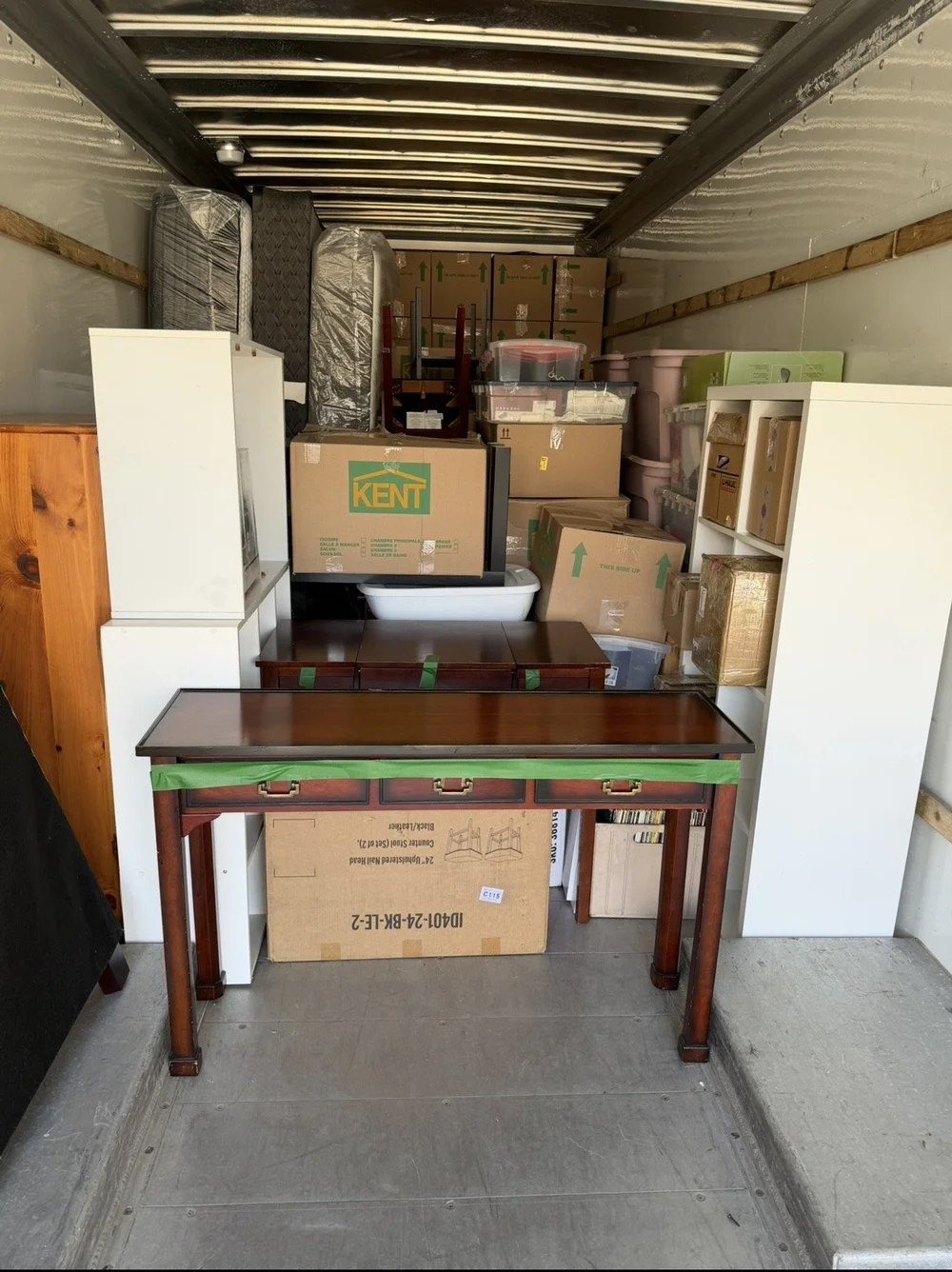 A full truckload of boxes, shelving and a wooden console table packed for a full house move in Nova Scotia.